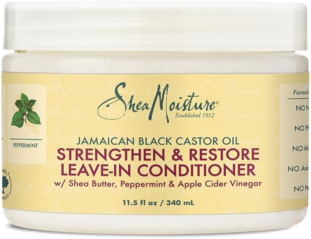 Shea Moisture Jamaican Black Castor Oil Strengthen & Restore Leave-In Conditioner, 11.5 oz jar. Close-up of Shea Moisture leave-in conditioner with shea butter, peppermint, and apple cider vinegar.